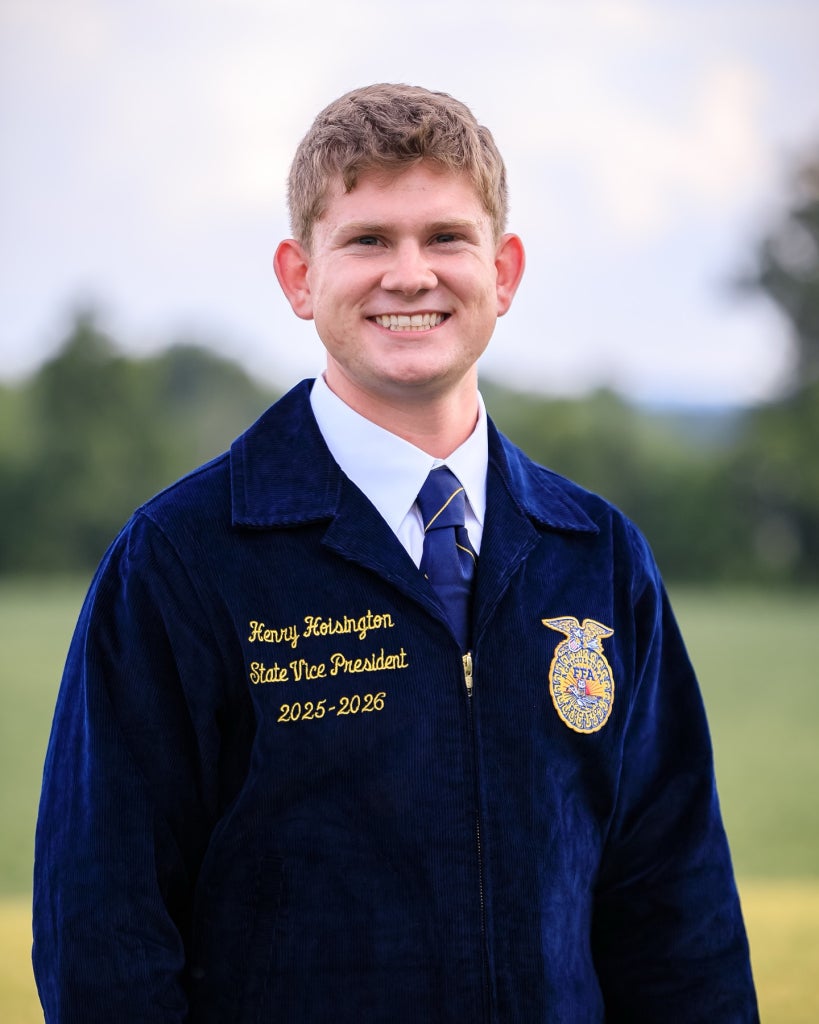 Ohio FFA State Vice President Henry Hoisington poses in his official blue FFA jacket.