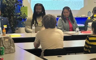 Panelists speaking to students about their agriculture experiences.