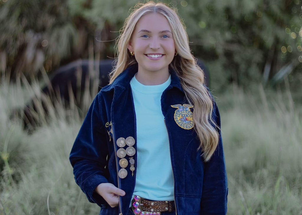 Chloe Branaman proudly shows the pins she has earned throughout her FFA journey.