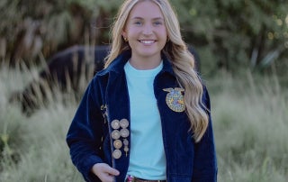 Branaman proudly shows the pins she has earned throughout her FFA journey.