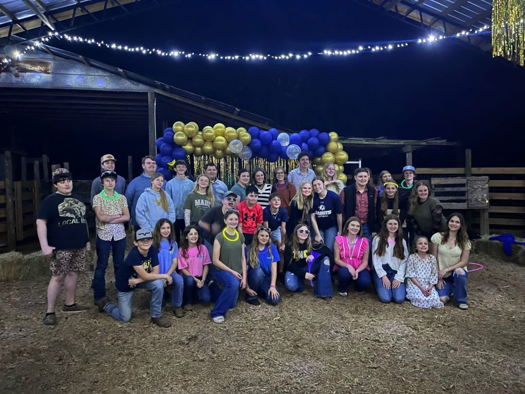 After a night of music and dancing at the Barn Bash, Chiefland FFA members pose for a group photo.
