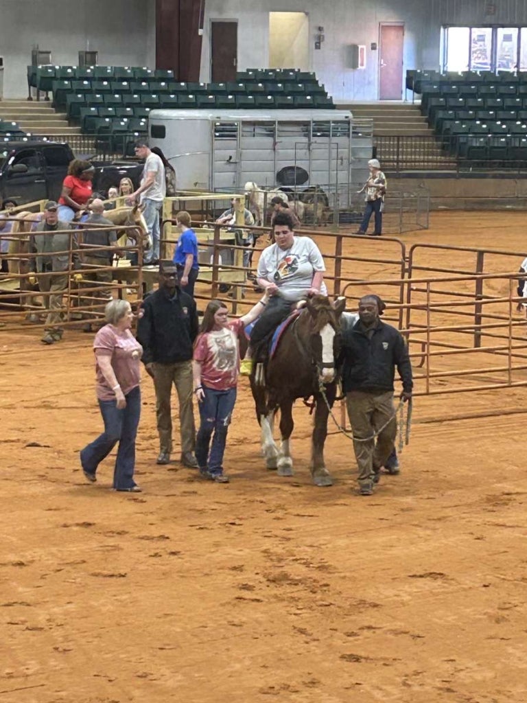 Forest-Scott FFA members and Refuge Roundup volunteers assisting special needs community members with horse riding.