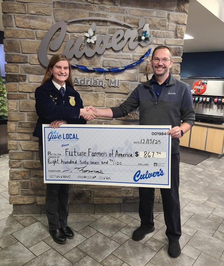 Mitchell, a Michigan FFA Culver’s Ambassador, receives a check from the Adrian, Mich., Culver’s location for her hard work with the company.