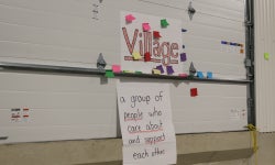 FFA members use sticky notes to discuss the meaning of a village.