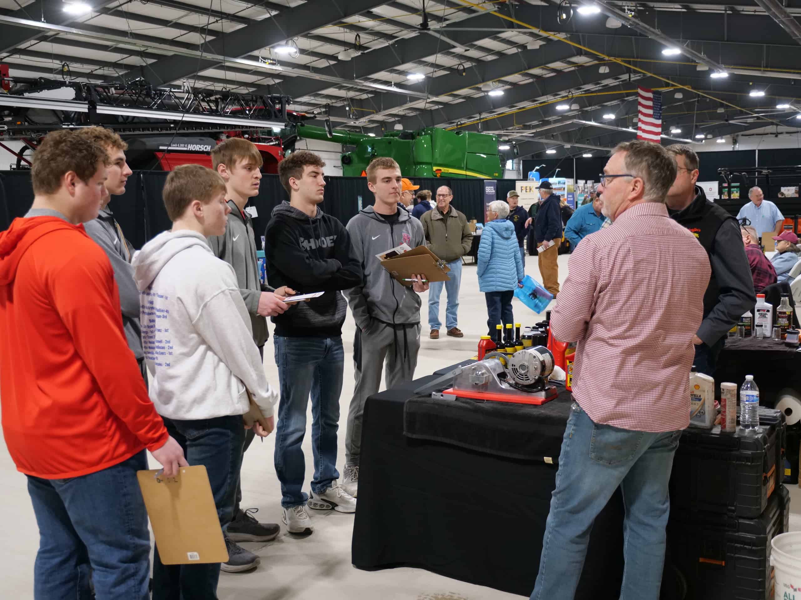 Members of the Patrick Henry FFA chapter talk with an exhibitor.