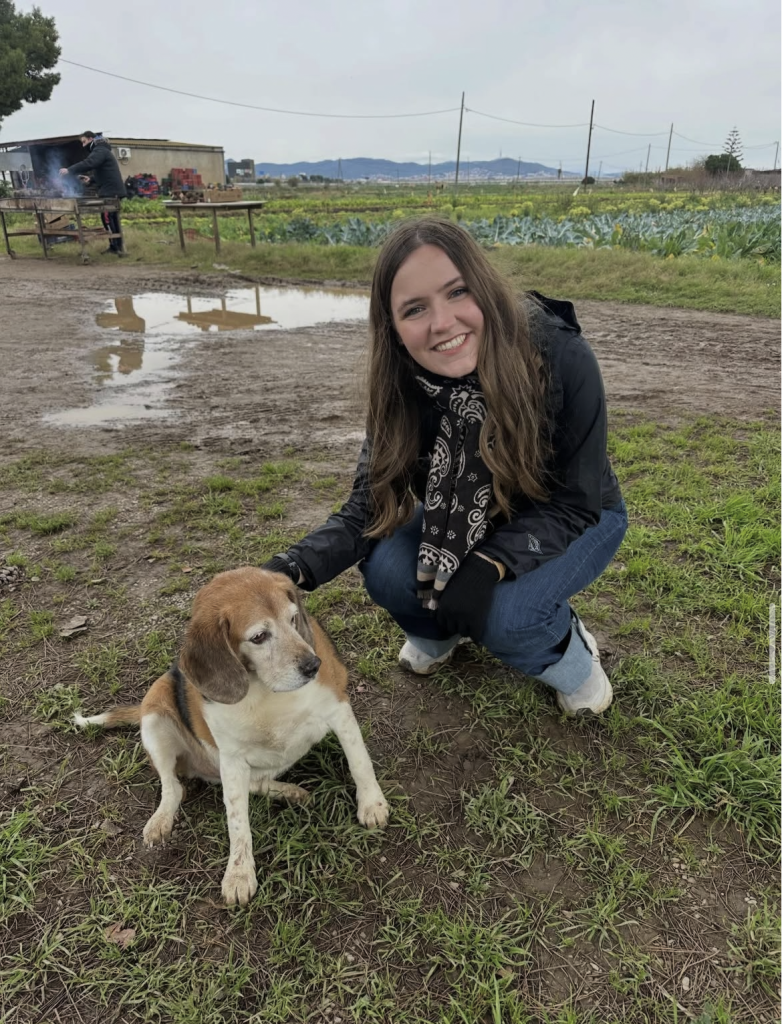 Garland meets a farm dog during a visit to an organic regenerative produce farm near Barcelona.