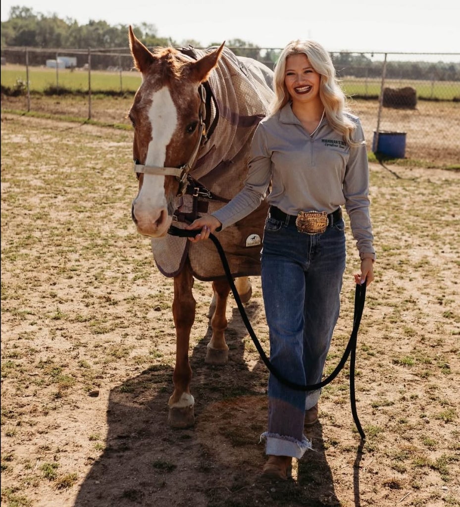  Gautz walks a horse, combining her love for agriculture and hands-on leadership.