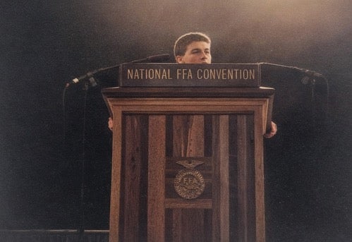 Reed speaking on stage at the National FFA Convention during his high school FFA days. 
