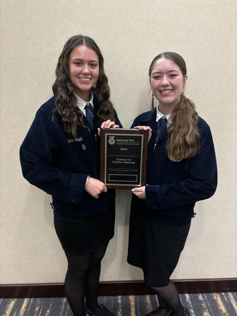 Kylee Smith (left) and Moore (right) pose for a picture after competing in the Conduct of Chapter Meetings Leadership Development Event at the 97th National FFA Convention &amp; Expo