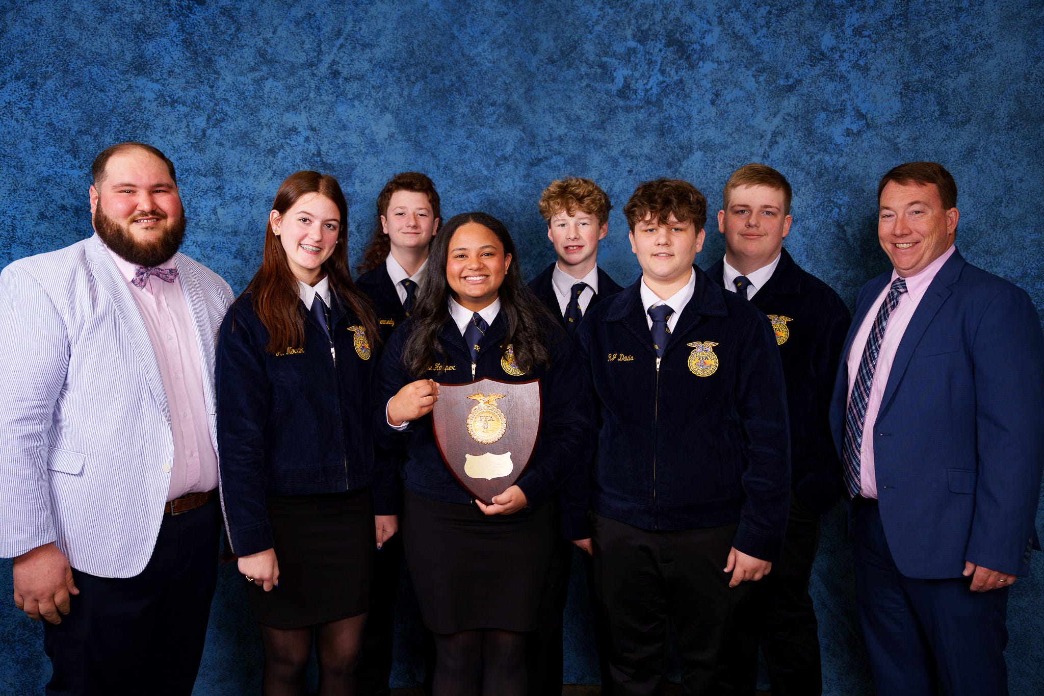 CCM team members and their advisors, Aaron Walls and Tyler Vester, show off their state-winning plaque.