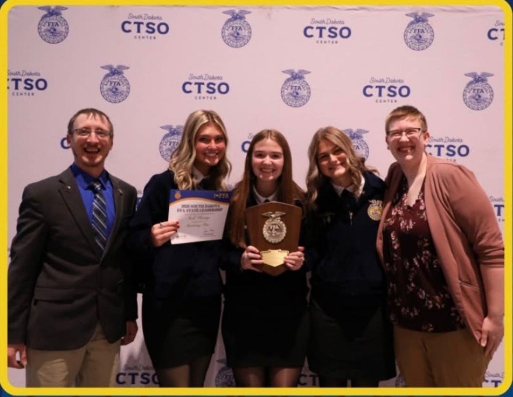 The Brookings FFA Ag Marketing Team poses for a photo with their advisors after qualifying for nationals.