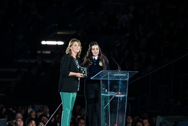 Sperling receiving recognition as the new California FFA state advisor and a “token of appreciation” from State Sentinel Sophia Camou. Photo taken by California FFA Press Corp. member Christopher Galvez of the Buena Park FFA Chapter.