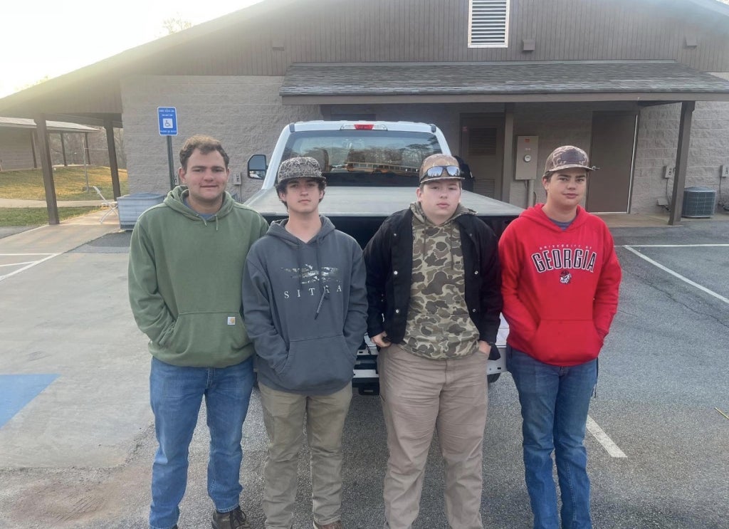 Kameron Smoak (far right) prepares to compete in the agricultural mechanics career development event.