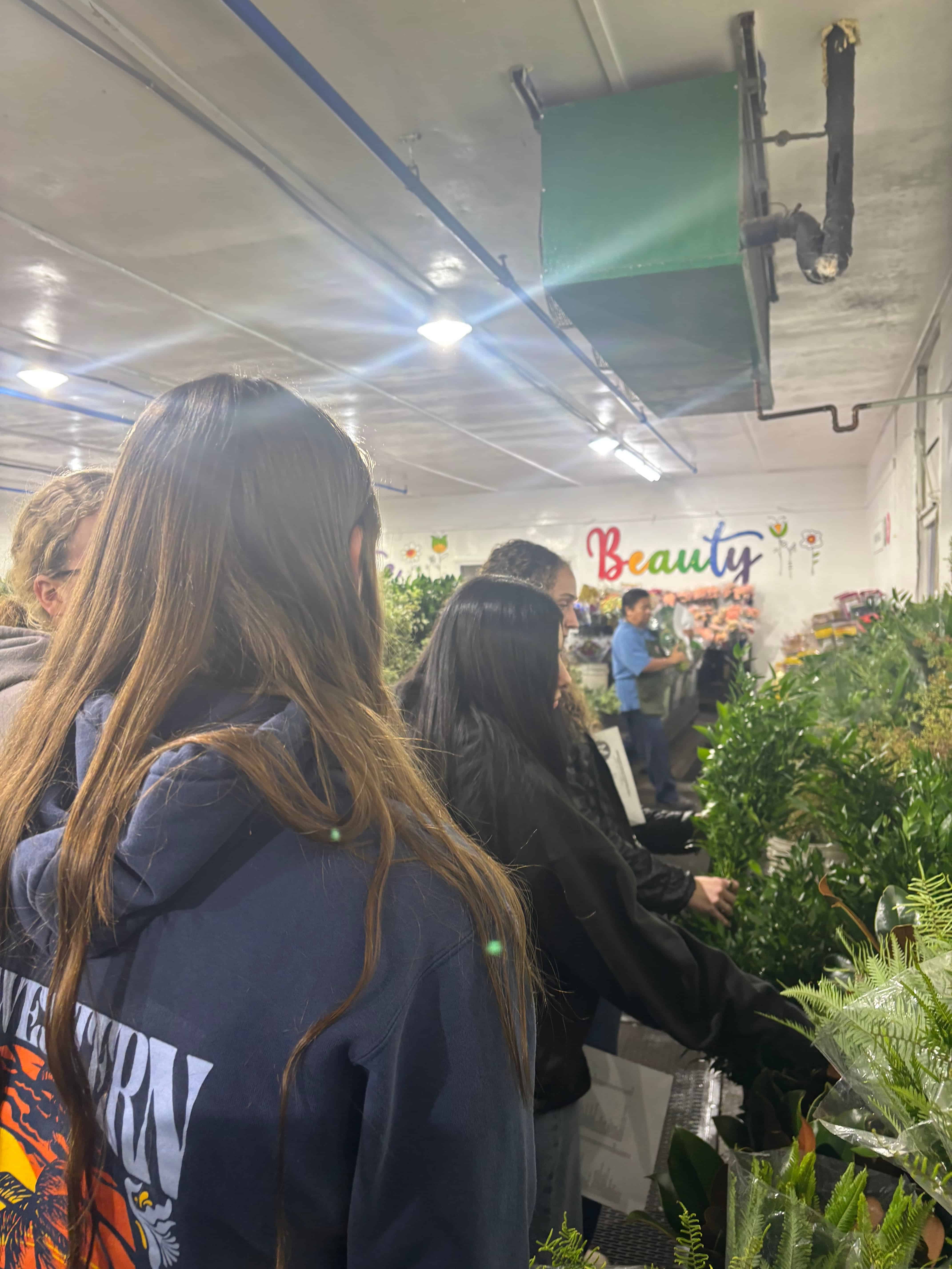 Members go through the greens section at Flora Fresh Inc. to pick out their foliage for the wreath.