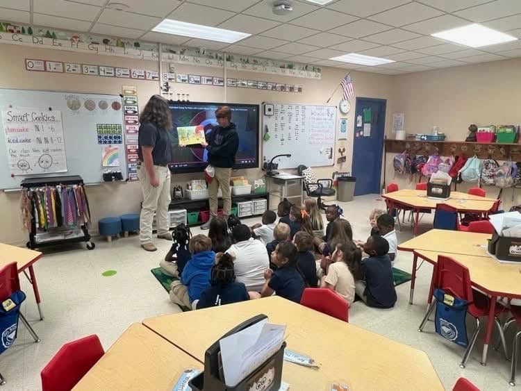 FFA members Coen Guice and Zachary Bailey read a book about agriculture to kindergarteners.