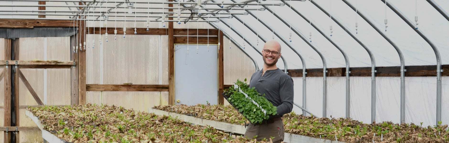 Drew poses with a flower grown at Clara Joyce Flowers.