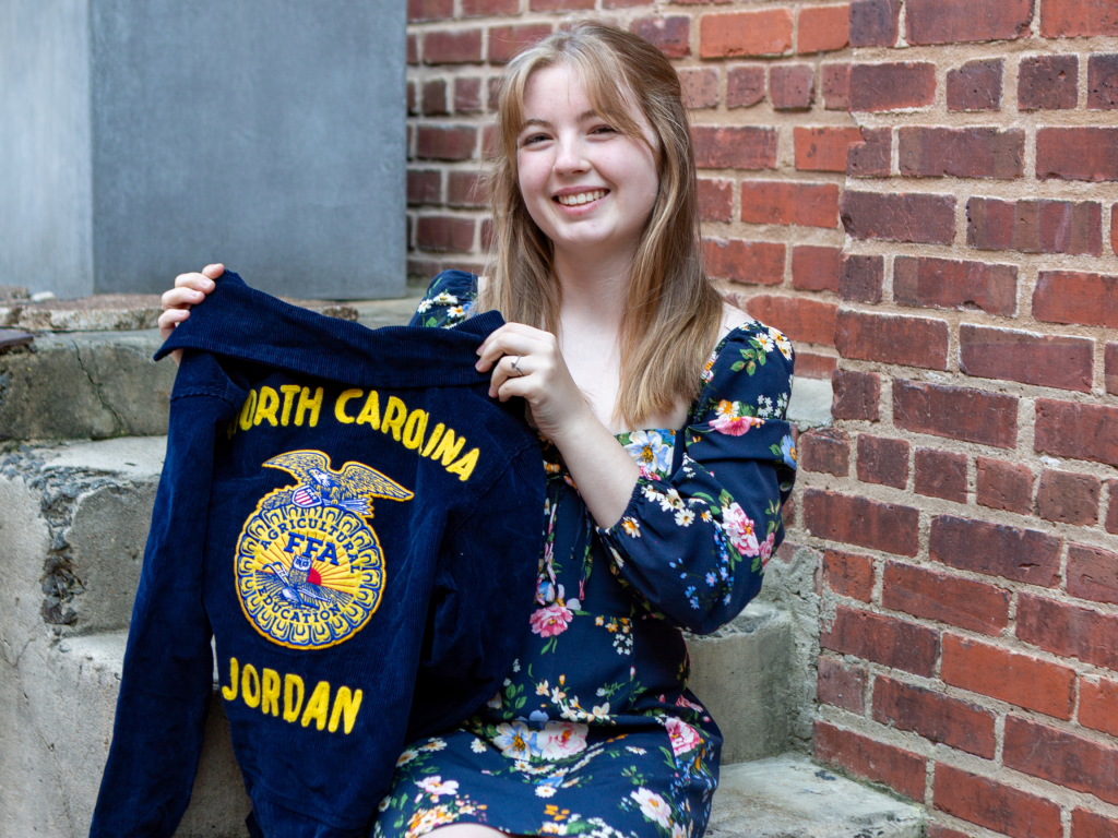 Lila Christie proudly holds her FFA jacket.