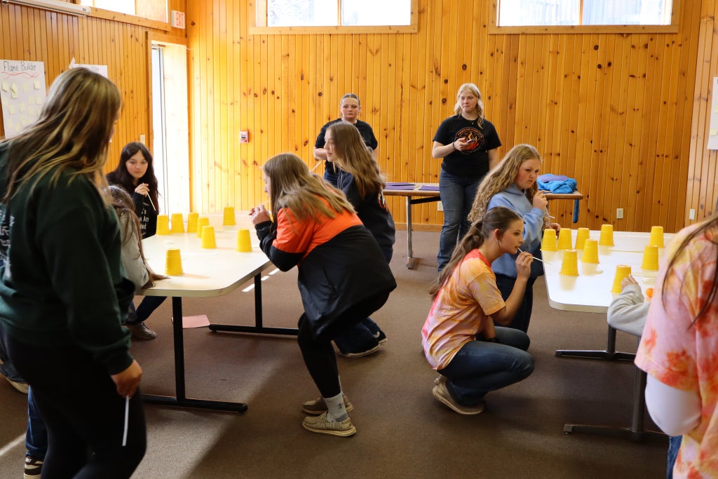 Kenzie Wolfe, Region II District II vice president (right), and Haylee Shamplo, Region II District I vice president (left), facilitating their camp workshop for a group of members.