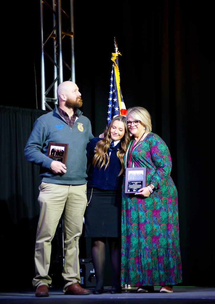 Wilde presents her advisors with plaques at Utah FFA State Convention.