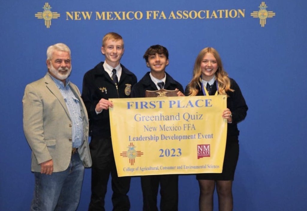 Widner poses with his state champion greenhand quiz team, consisting of Cade Lee, Chris Hernandez and Maddie Kenyon.