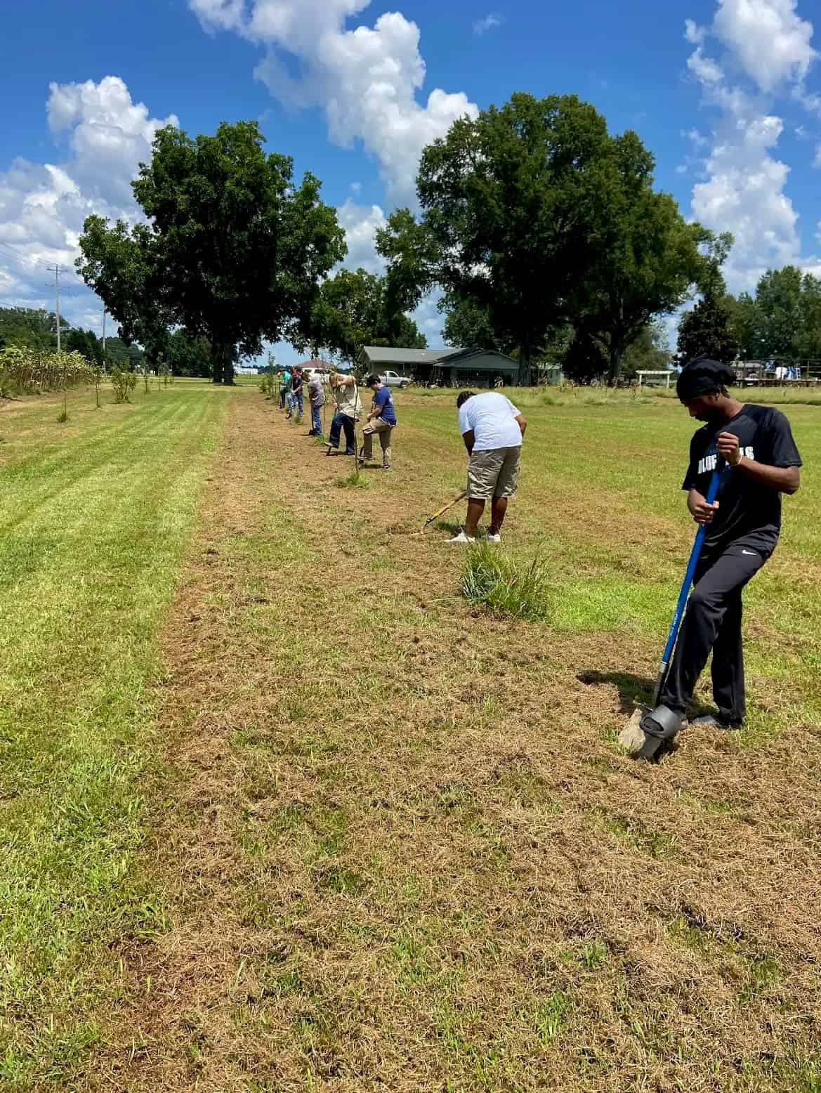 Members engaging with planting of the gardens that give back to the community and animals.