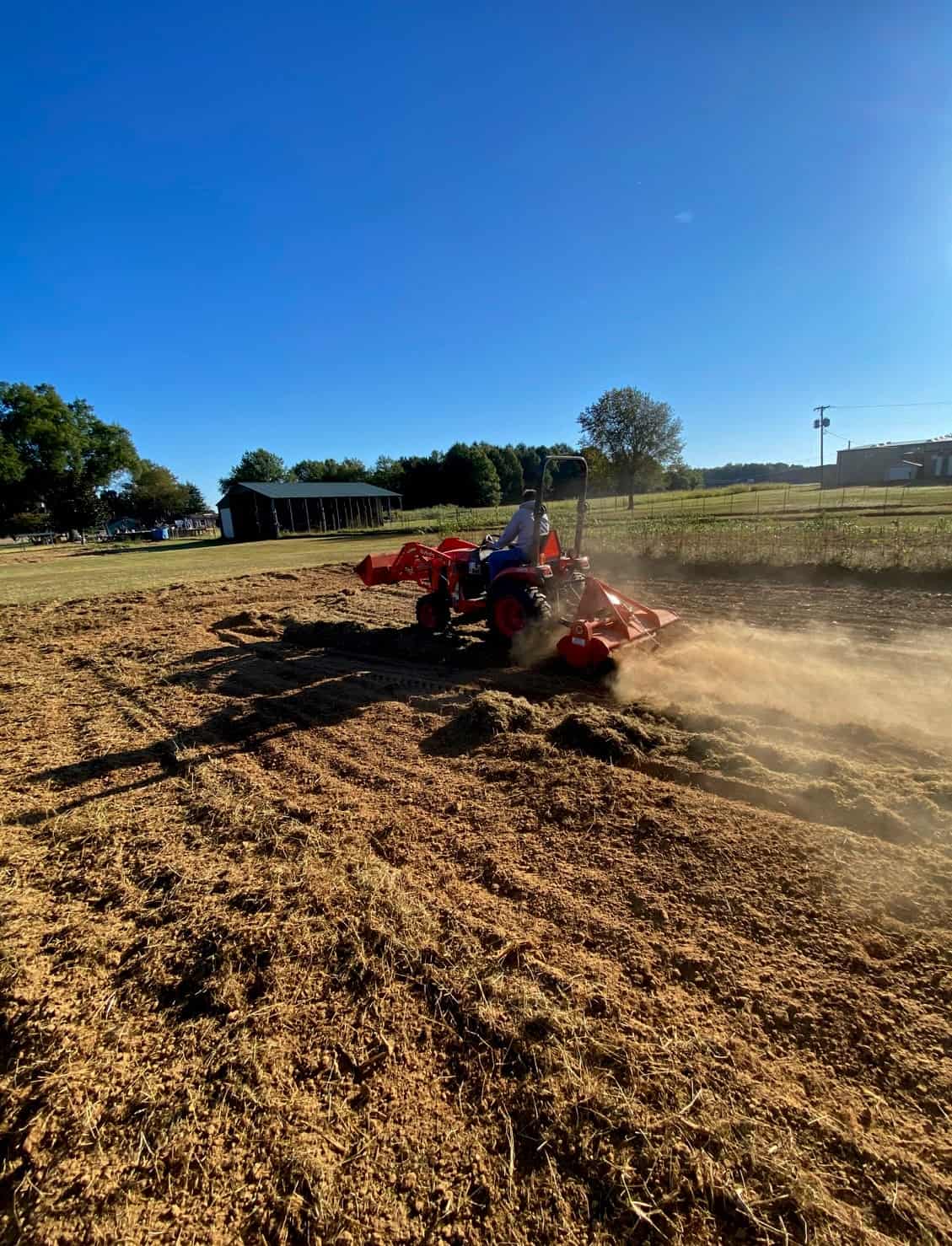 Students learn how to operate a tractor for bailing the agriculture program’s hay for its livestock.