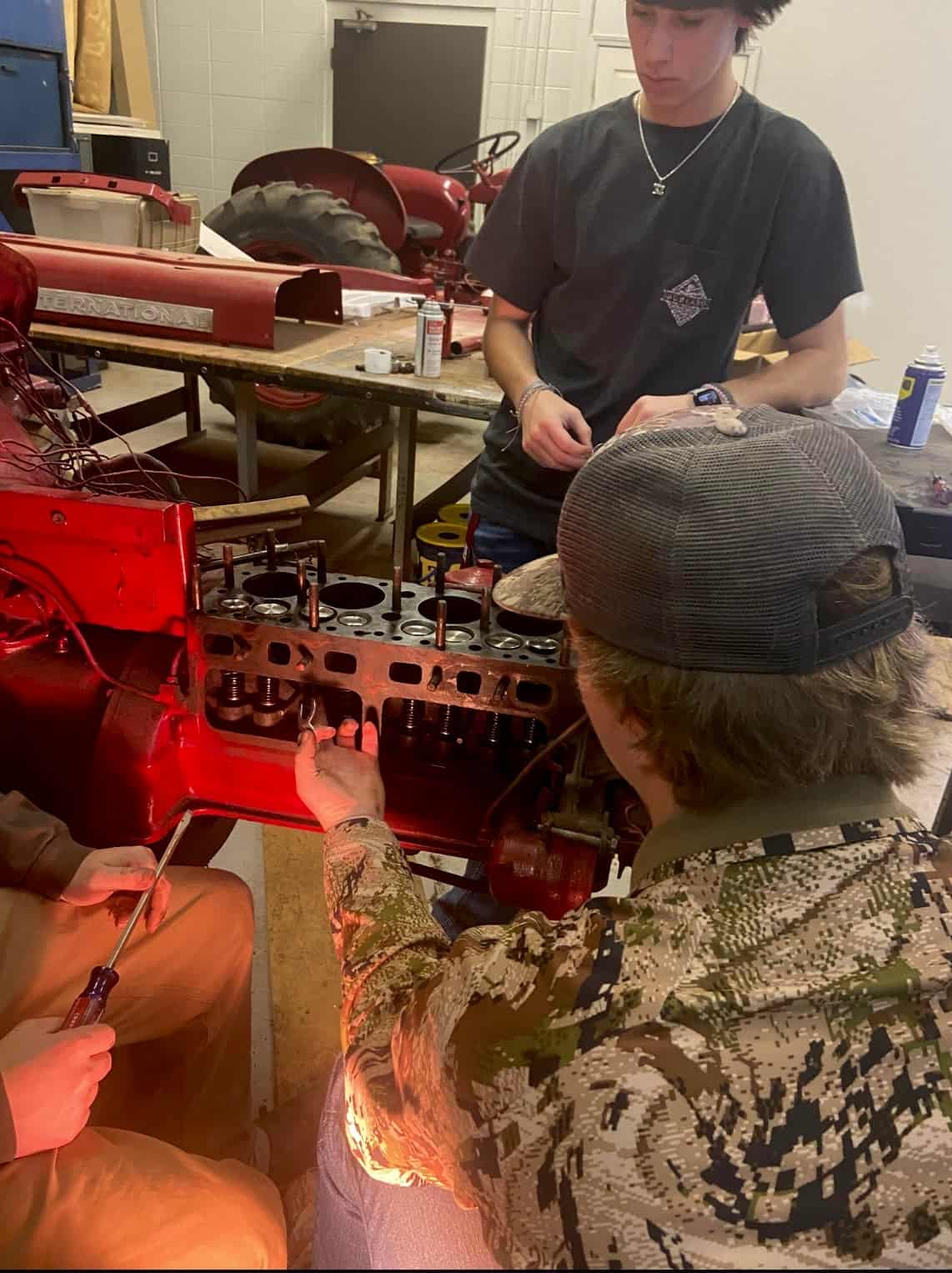 Students who are interested in mechanics cultivate skills to restore tractors that are donated to the school’s program.
