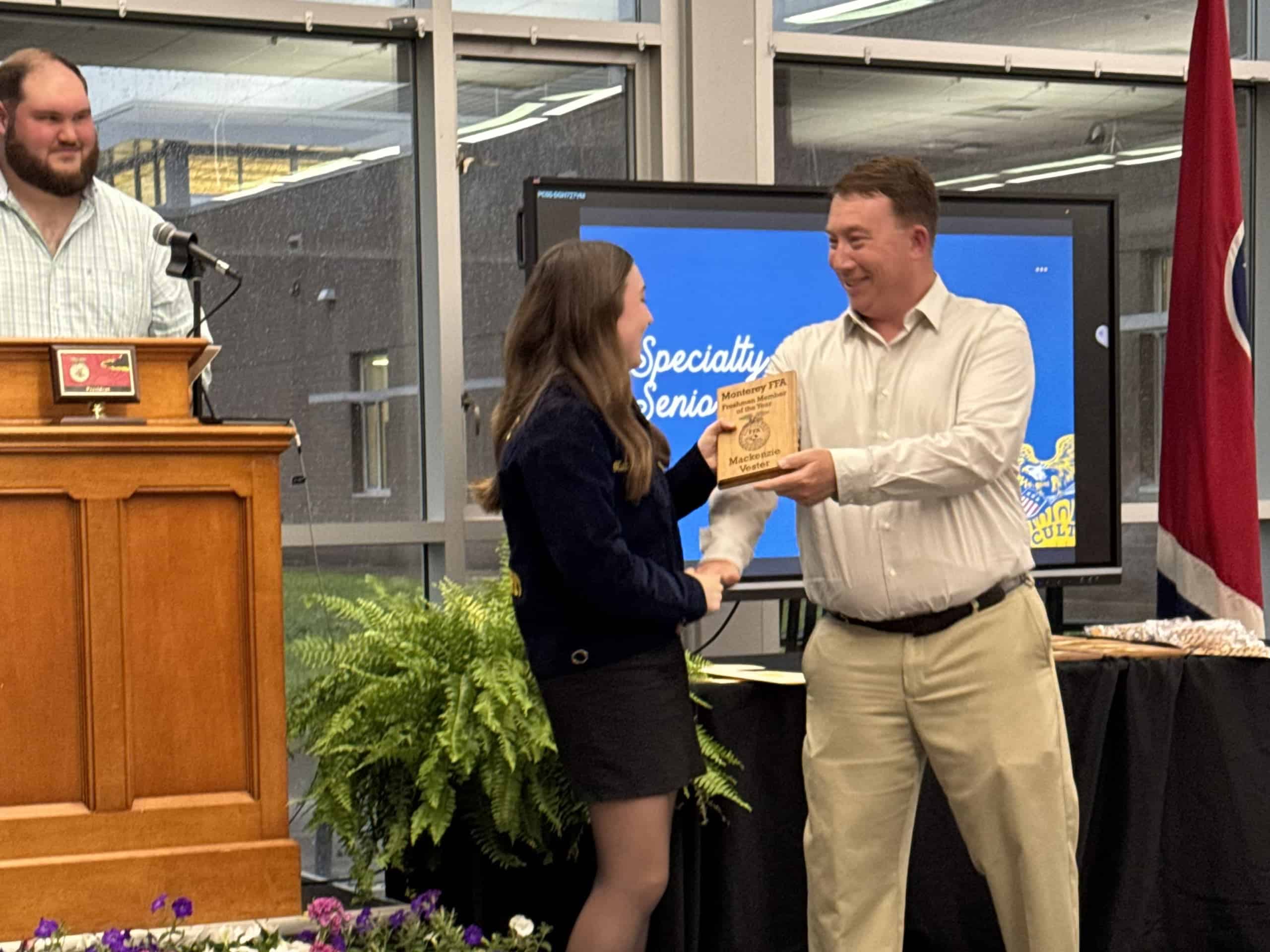 My dad, Tyler Vester, presenting me with the Freshman Member of the Year plaque.