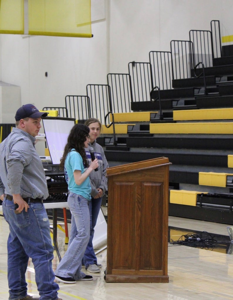 Wheeler speaking through a microphone to a crowd.
