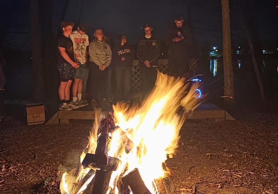 The 2025-26 officer team standing outdoors, reading their retiring addresses to members as the last camp activity.