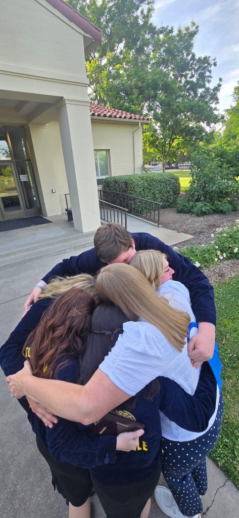 Team members hugging after they found out they won state finals.