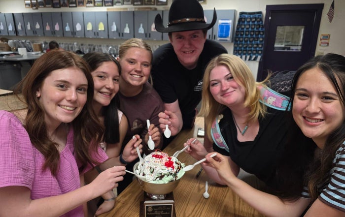 Susanville FFA's Advanced Parliamentary Procedure team eating icecream out of their state champion bowl.