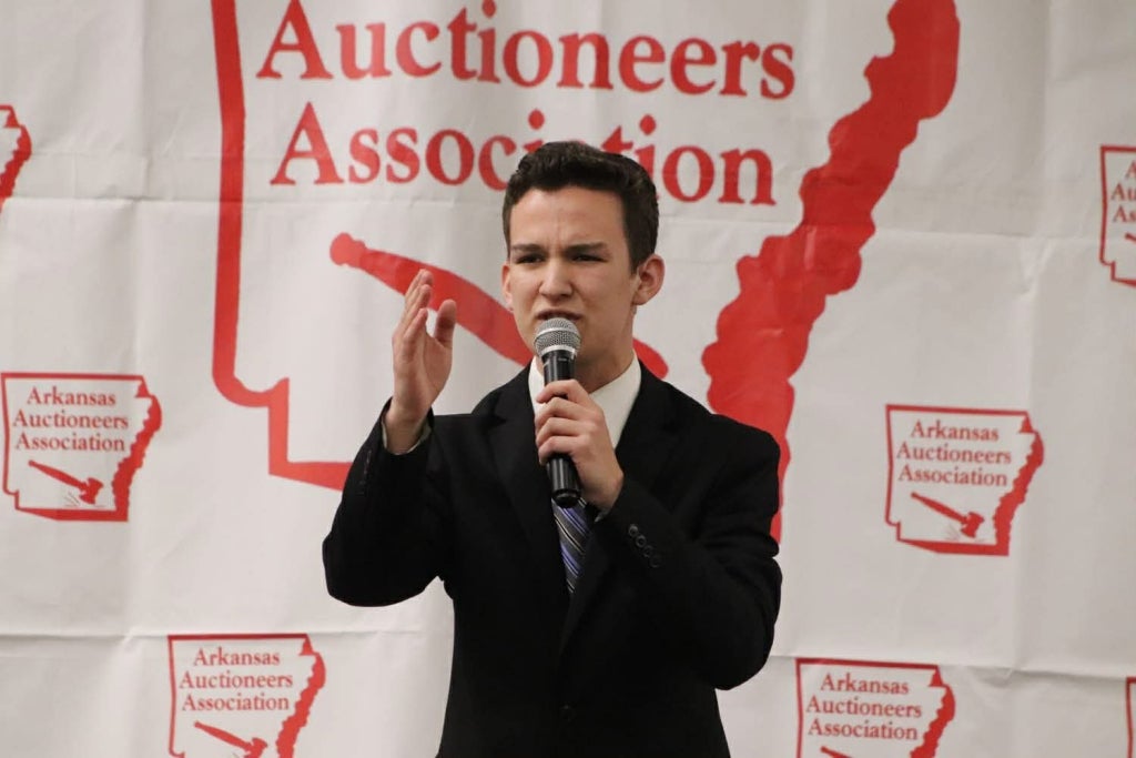 Leo Enlow auctioneers, showcasing the communication skills and presence that have become hallmarks of his leadership.