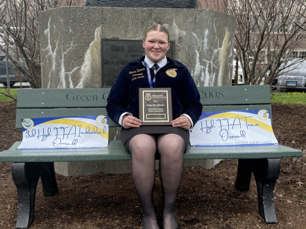 Sierra Hemond posing with her awards