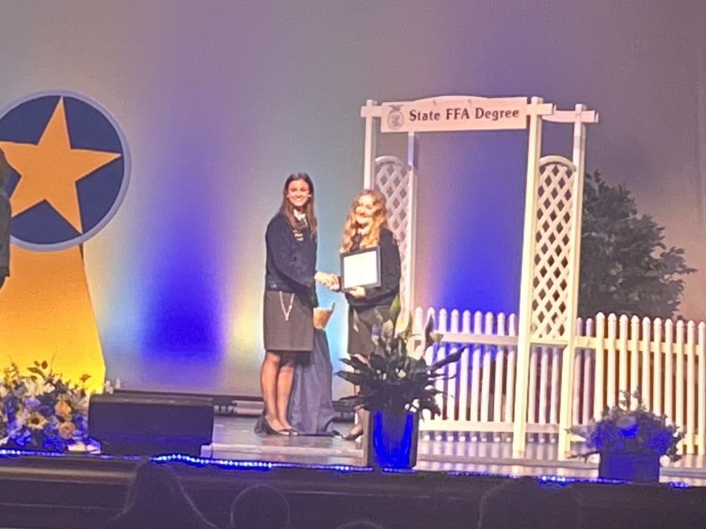 McKenzie accepting her State FFA Degree.