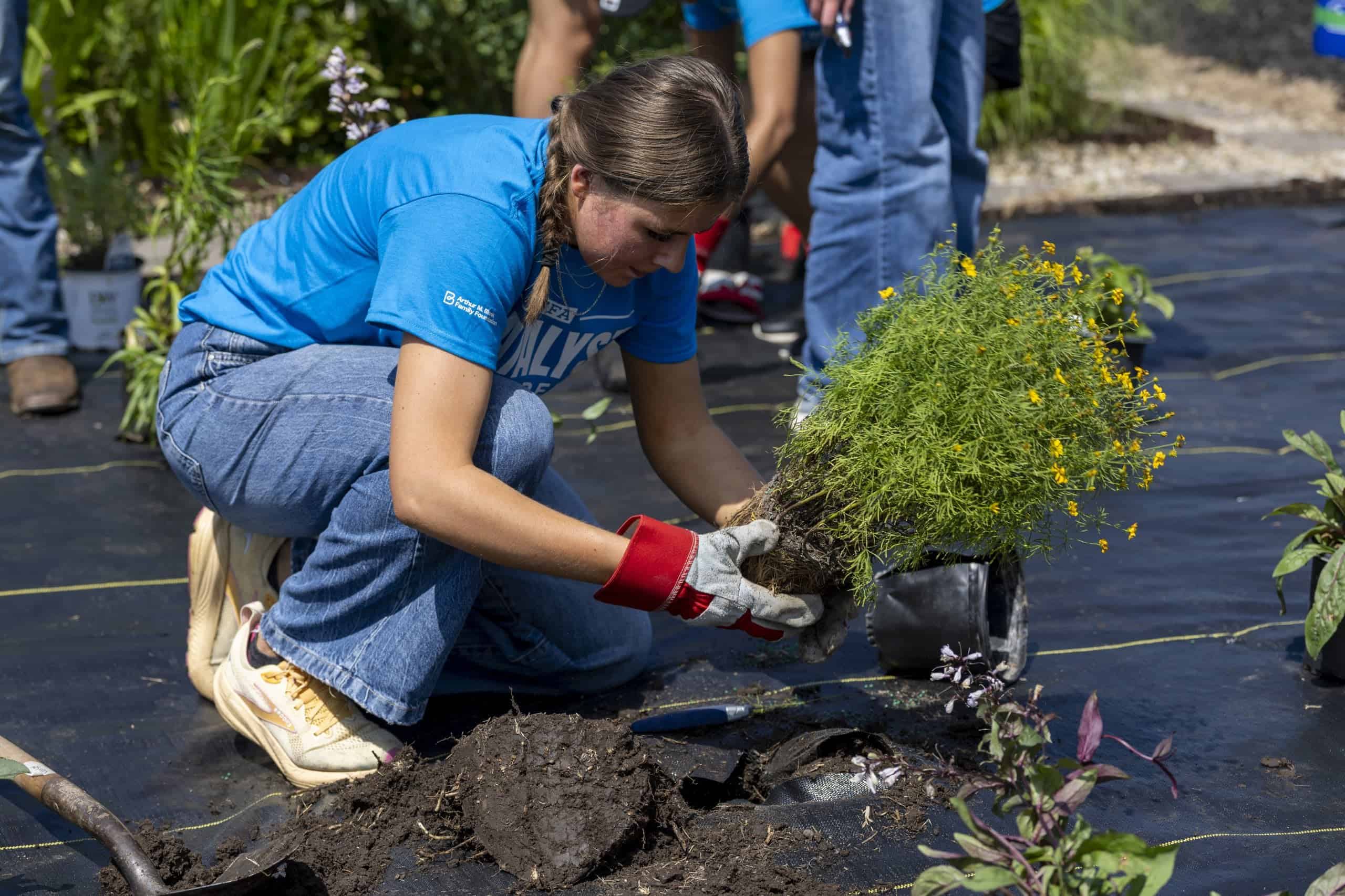 FFA Member Planting Seedling at Conference