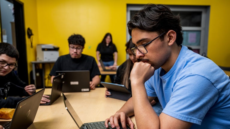 Student Works on Laptop in Classroom
