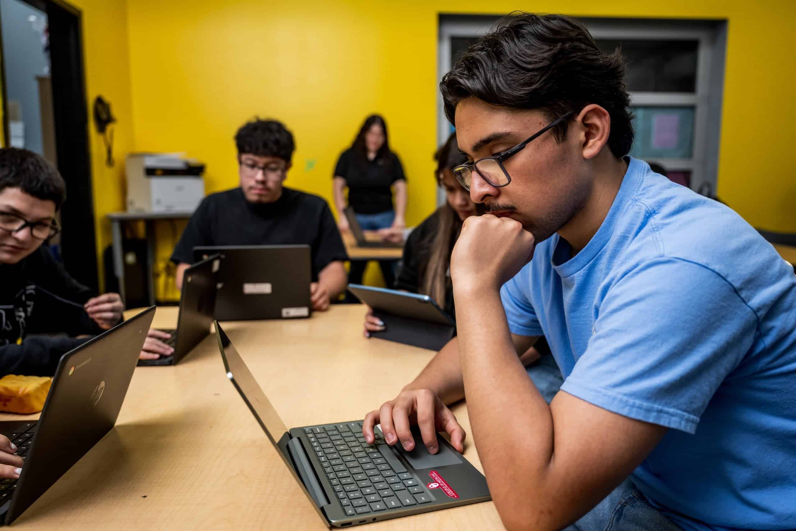Student Works on Laptop in Classroom