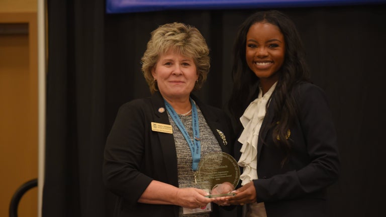 alumni revieving award at the alumni and supporters awards luncheon