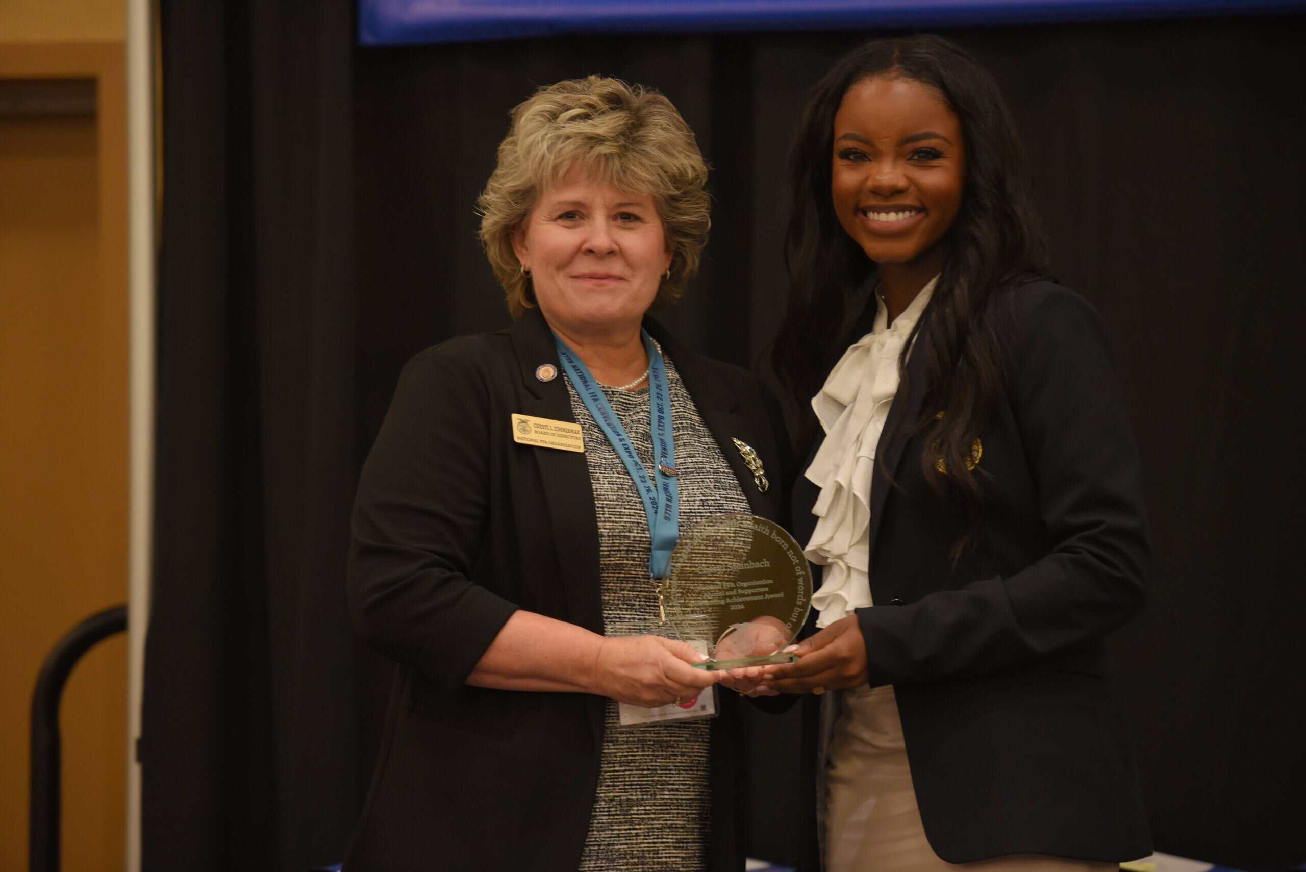 alumni revieving award at the alumni and supporters awards luncheon