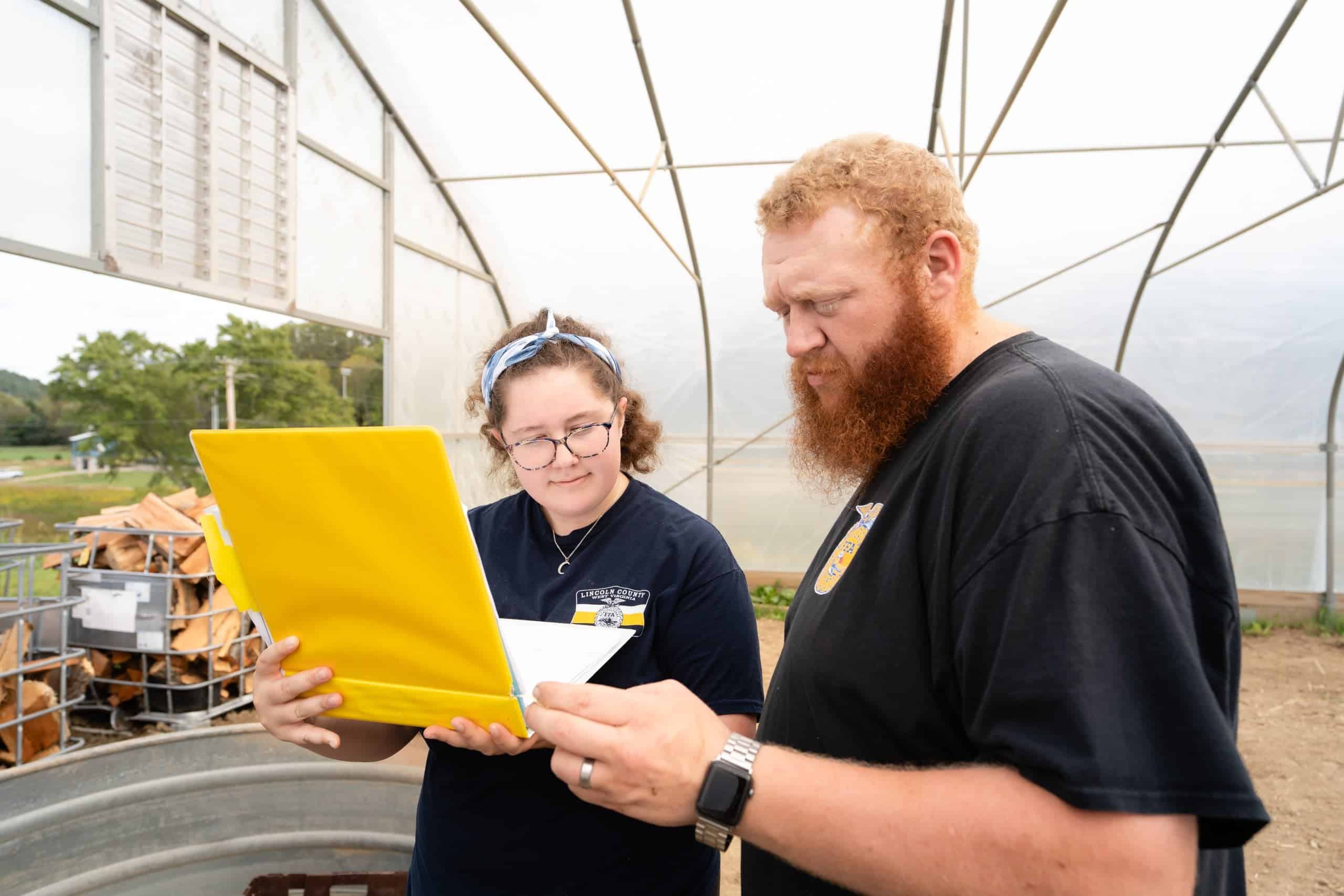 FFA Advisor Discusses Yellow Educational Material with Student