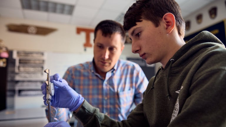 Student explores fire prevention equipment in lab setting