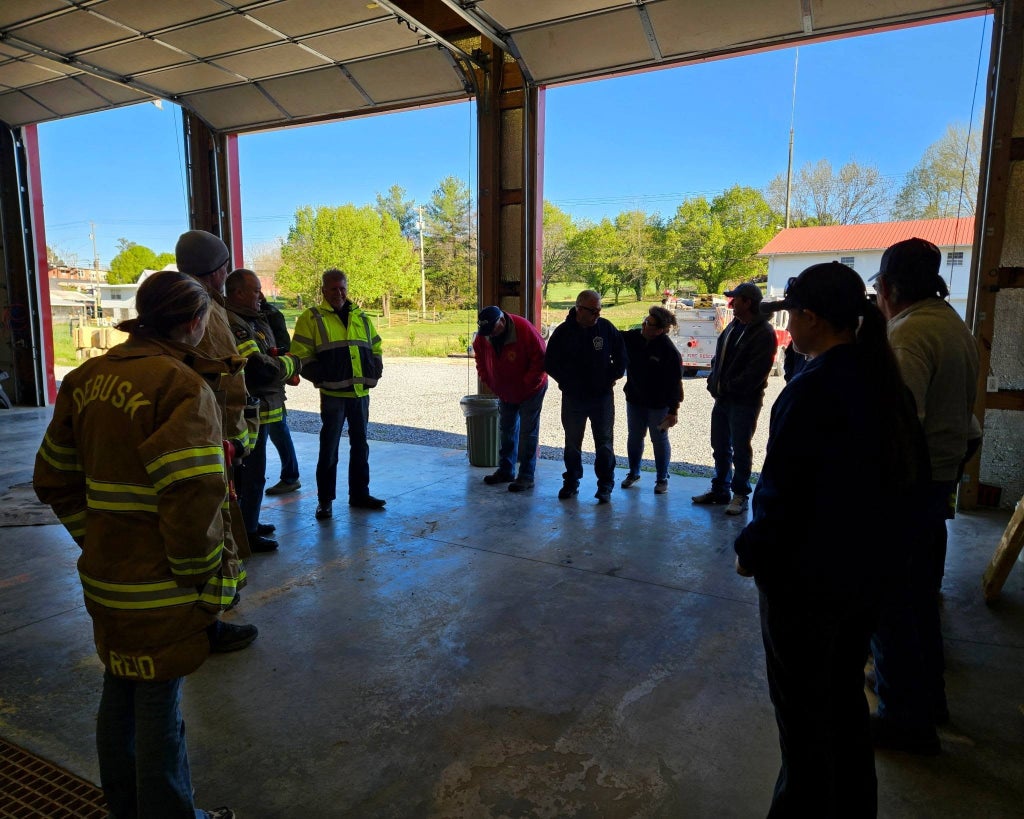 Firefighters and attendees from several departments gather inside Debusk Volunteer Fire Department for a SoyFoam demonstration briefing.