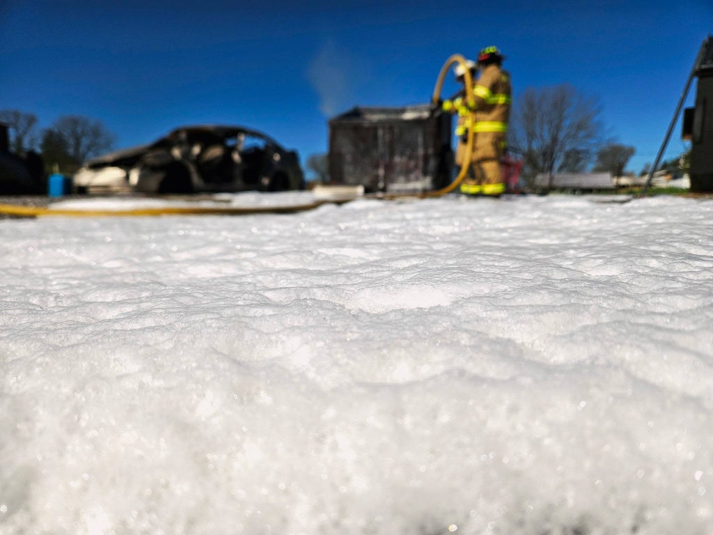 SoyFoam blankets the training area after application during a live fire demonstration at Debusk Volunteer Fire Department.