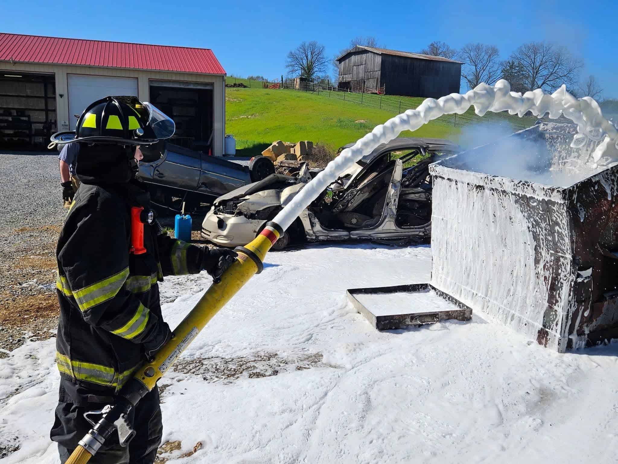 Dakine Thompson, a junior member of Tusculum Volunteer Fire Department, applies SoyFoam during a live fire demonstration.